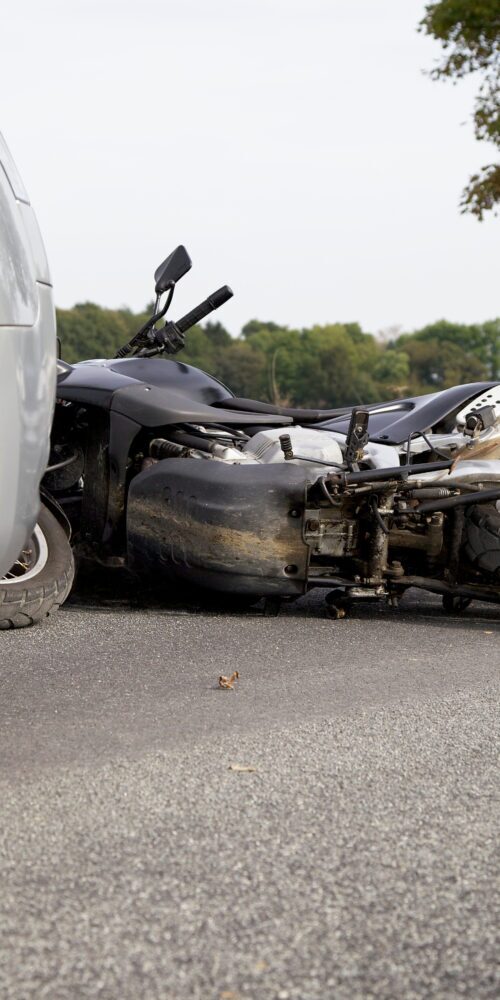 Motorcycle Accident between a silver car an black motorcycle. Filing a Dallas Motorcycle Accident Claim with No Helmet