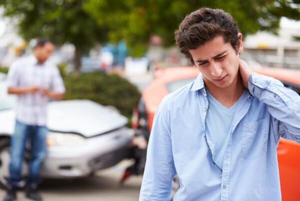 Teenage Driver Suffering Whiplash Injury Traffic Accident. Car Accident Injuries in Dallas
